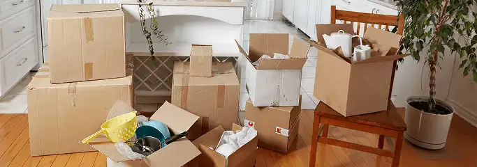 Packed moving boxes and household items in a kitchen before move-out or move-in cleaning, Dover, DE.